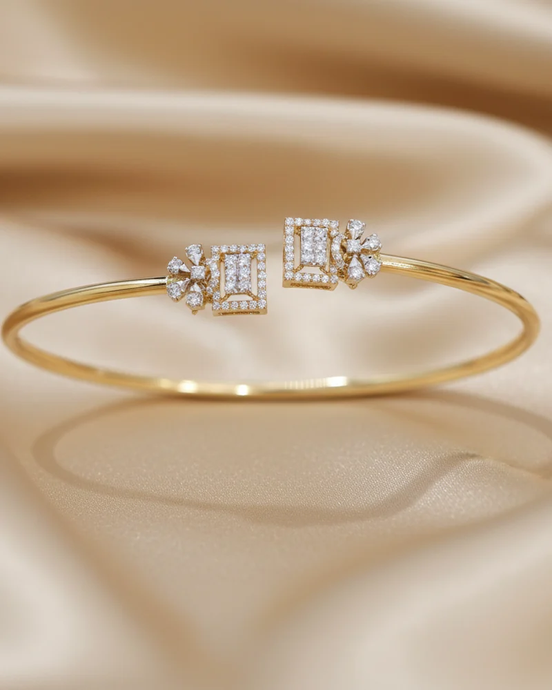 A fine gold bracelet with three stepped diamond panels at the centre.