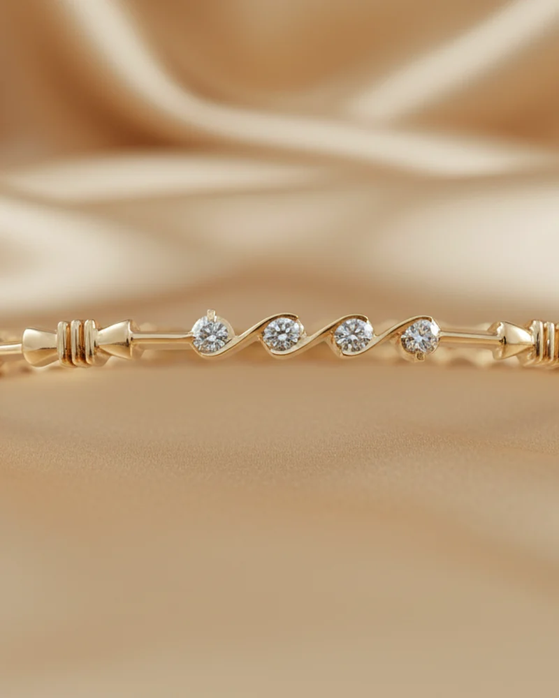 A gold bangle set with a line of baguette and round diamonds.