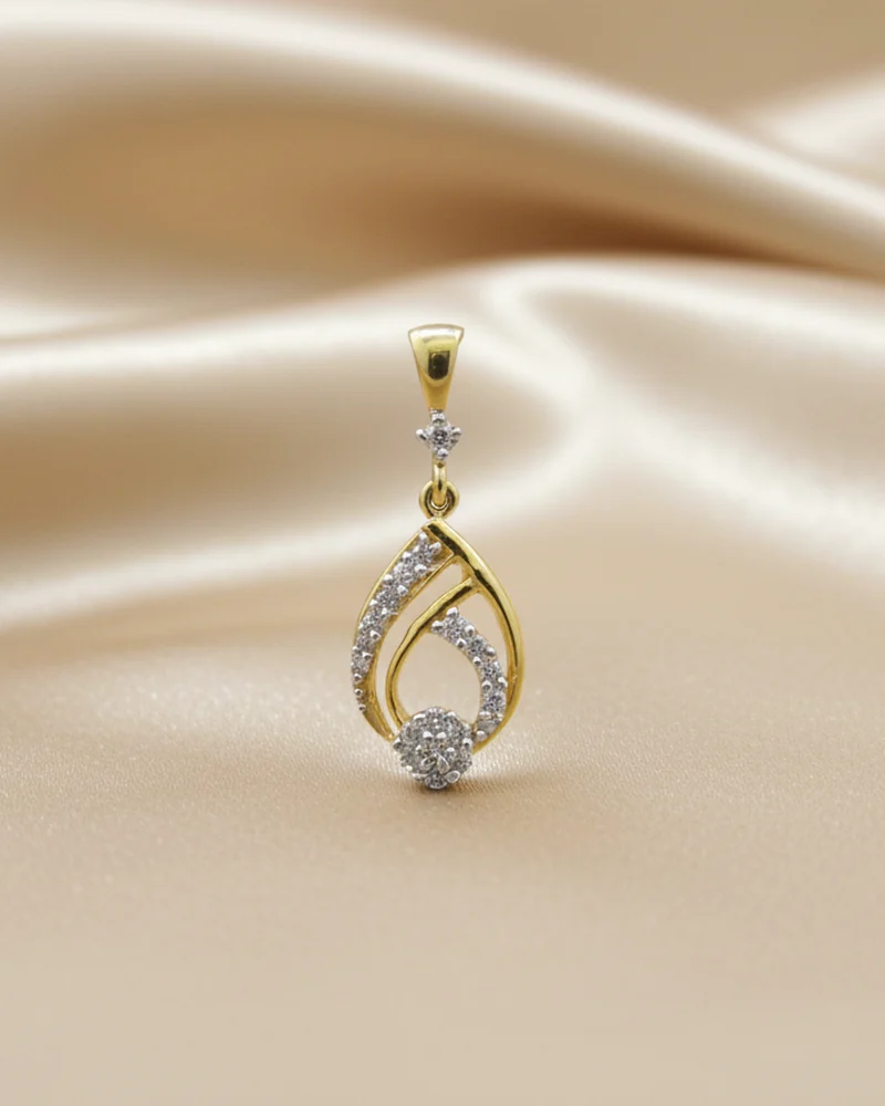 A gold teardrop pendant outlined in diamonds.