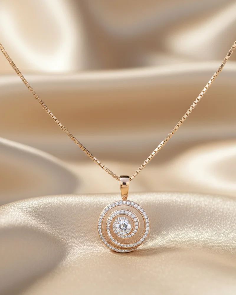 A round rose gold pendant with a diamond halo, on a fine chain.
