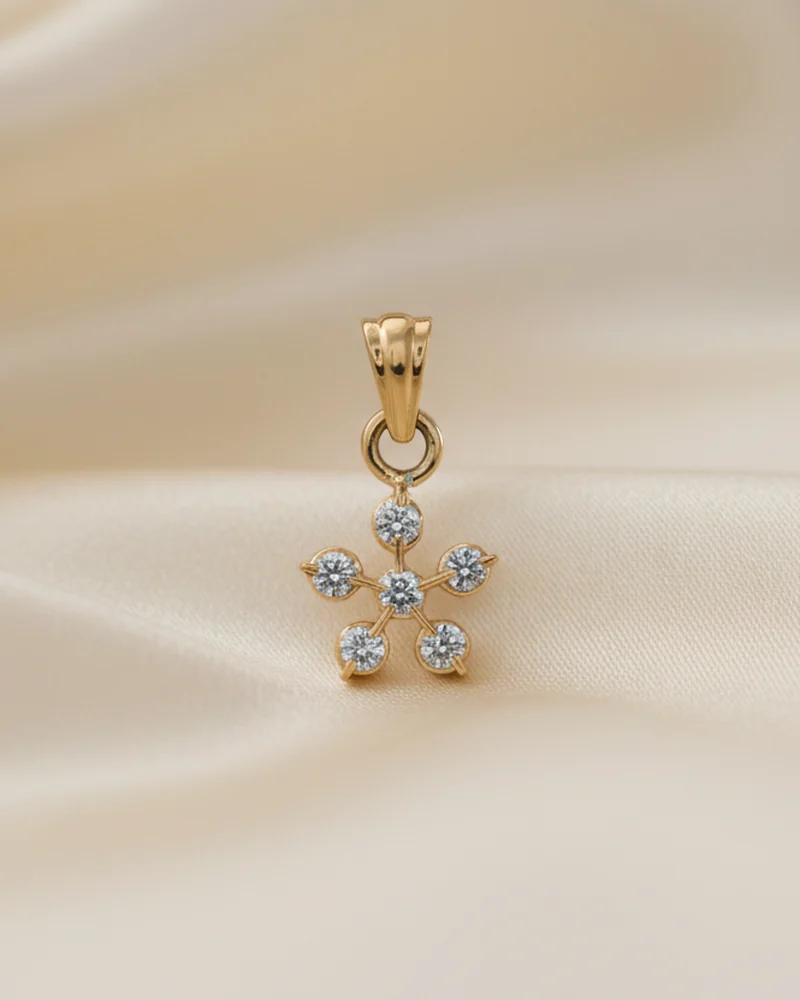 A small white gold pendant in a six point snowflake of diamonds.