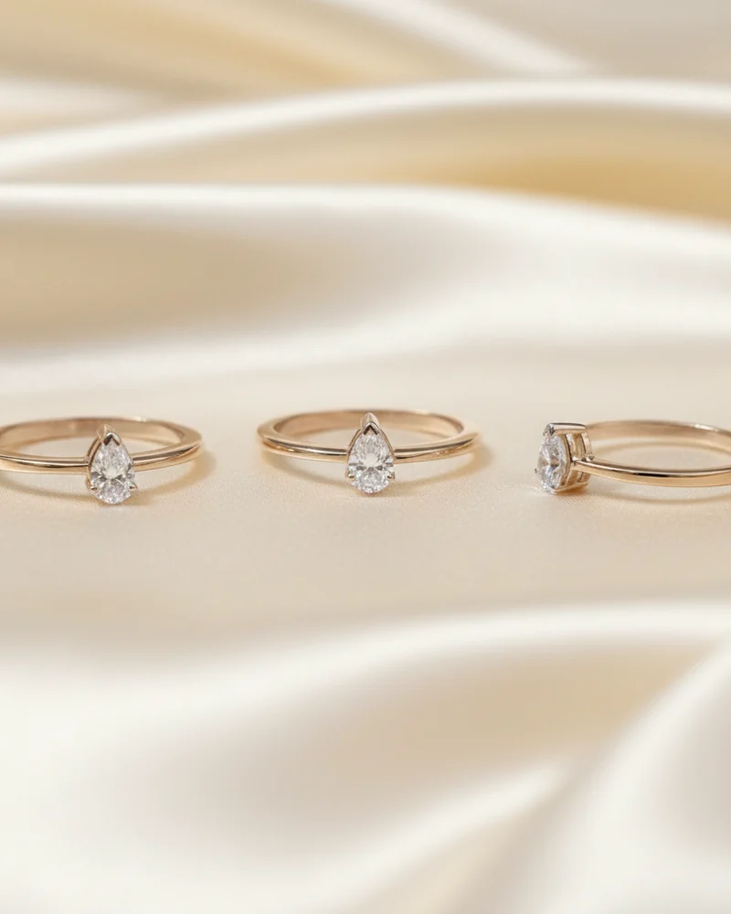 Three slim gold rings meant to be worn stacked, each with its own diamond.